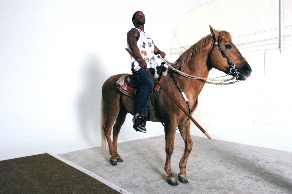 model posing for Rumors of War series with a horse, 2005. © Kehinde Wiley.