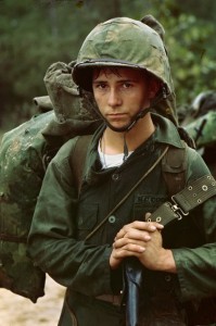 A young Marine private waits on the beach during the Marine landing, 1965, Da Nang, Vietnam, By an unknown photographer, August 3, 1965, courtesy of the National Archives and Records Administration, Records of the U.S. Marine Corps.